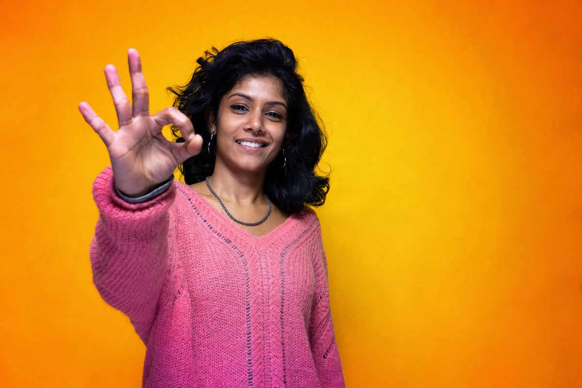 Young Woman Doing OK Hand Gesture